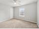 Cozy bedroom featuring a ceiling fan and a window for natural light at 5002 Abode Lily Ln, Charlotte, NC 28227