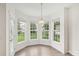 Sunny dining area featuring large windows and a stylish pendant light fixture at 5002 Abode Lily Ln, Charlotte, NC 28227