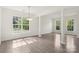 Bright living room with large windows, wood floors and decorative columns at 5002 Abode Lily Ln, Charlotte, NC 28227