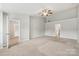 Large main bedroom featuring neutral colors, carpet, and a ceiling fan at 5002 Abode Lily Ln, Charlotte, NC 28227
