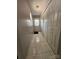 Hallway with tiled floors leads to the front door and features a closet with sliding doors for storage at 501 N Johnson St, Monroe, NC 28112
