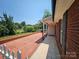 The red brick patio offers a relaxed outdoor space next to the house and well manicured yard at 501 N Johnson St, Monroe, NC 28112