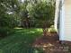 Well-maintained backyard with a tree and beautiful landscaping offering a serene escape at 509 Settlers Grove Ln, Salisbury, NC 28146