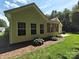 Beautiful backyard featuring lush green grass, a screened in porch, and manicured landscaping at 509 Settlers Grove Ln, Salisbury, NC 28146