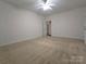 Spacious carpeted bedroom features a ceiling fan and neutral paint, creating a calming atmosphere at 509 Settlers Grove Ln, Salisbury, NC 28146