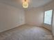 Comfortable bedroom with neutral carpet, a window providing natural light, and a closet at 509 Settlers Grove Ln, Salisbury, NC 28146