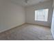 Bright bedroom with a large window and neutral carpet, creating a comfortable living space at 509 Settlers Grove Ln, Salisbury, NC 28146