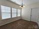 Bright breakfast nook with tile flooring, large windows, and a classic chandelier at 509 Settlers Grove Ln, Salisbury, NC 28146