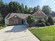 Charming home featuring a well-manicured lawn, brick accents, and a spacious driveway at 509 Settlers Grove Ln, Salisbury, NC 28146