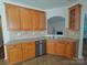 Cozy kitchen with stainless steel dishwasher, tiled backsplash, and ample cabinet storage at 509 Settlers Grove Ln, Salisbury, NC 28146
