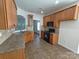 Spacious kitchen with a tiled floor, wooden cabinets and black gas range at 509 Settlers Grove Ln, Salisbury, NC 28146