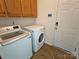 A modern laundry room featuring a washer, dryer, and ample cabinet space for storage at 509 Settlers Grove Ln, Salisbury, NC 28146