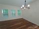 Bright dining room with hardwood floors, large windows, and modern chandelier at 509 Settlers Grove Ln, Salisbury, NC 28146