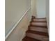 Wooden staircase with a white handrail, leading to the upper levels of the home at 509 Settlers Grove Ln, Salisbury, NC 28146