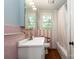 Functional bathroom with a standard sink, tub and shower, and pink tile accents at 5111 Tewkesbury Rd, Charlotte, NC 28269