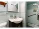 Modest aqua bathroom with a vanity, toilet, and accessible shower with safety bars at 5111 Tewkesbury Rd, Charlotte, NC 28269