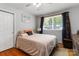 Comfortable bedroom with hardwood floors and large window for natural light at 5111 Tewkesbury Rd, Charlotte, NC 28269