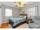 Cozy bedroom featuring a ceiling fan, wood floors, natural light and comfortable furnishings at 5111 Tewkesbury Rd, Charlotte, NC 28269