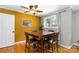Bright dining room with wooden table and chairs, complemented by modern lighting and a window view at 5111 Tewkesbury Rd, Charlotte, NC 28269