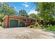 Exterior view of a home with a brick facade, attached garage, and a wooden ramp at 5111 Tewkesbury Rd, Charlotte, NC 28269