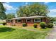 Inviting brick home with a well-maintained lawn and mature landscaping at 5111 Tewkesbury Rd, Charlotte, NC 28269