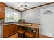 Cozy kitchen features a breakfast bar with wooden stools and a ceiling fan at 5111 Tewkesbury Rd, Charlotte, NC 28269