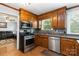 This kitchen features stainless steel appliances, wood cabinets, and ample counter space at 5111 Tewkesbury Rd, Charlotte, NC 28269