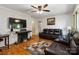 Cozy living room with hardwood floors, fireplace, and comfortable leather furniture at 5111 Tewkesbury Rd, Charlotte, NC 28269