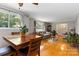 Open living space combining dining and living areas with hardwood flooring and ample natural light at 5111 Tewkesbury Rd, Charlotte, NC 28269