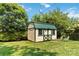 Outdoor shed with a green roof on a manicured lawn surrounded by greenery at 5111 Tewkesbury Rd, Charlotte, NC 28269