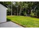 Expansive backyard featuring a lush lawn, mature trees, and a privacy at 512 Beverly Cir, Charlotte, NC 28270