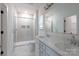 Bright bathroom featuring double vanity, quartz countertops, and a modern walk-in shower at 512 Beverly Cir, Charlotte, NC 28270
