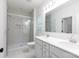 Modern bathroom featuring double vanity, quartz countertops, and a spacious walk-in shower with glass enclosure at 512 Beverly Cir, Charlotte, NC 28270