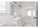 Well-lit bathroom with double vanity, quartz countertops, and doorway to bedroom at 512 Beverly Cir, Charlotte, NC 28270