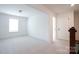 Neutral bedroom with carpet, bright window, and white walls featuring adjacent doorway at 512 Beverly Cir, Charlotte, NC 28270