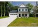 Charming two-story home with a two car garage, stone accents, and a well manicured front lawn at 512 Beverly Cir, Charlotte, NC 28270