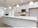 Open-concept kitchen with a view of the fireplace, stainless steel appliances, and a large island at 512 Beverly Cir, Charlotte, NC 28270