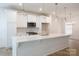 Well-lit kitchen boasts stainless appliances, quartz counters and white cabinetry at 512 Beverly Cir, Charlotte, NC 28270