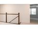 Upstairs landing with wood and white railing and a view to bedroom with natural light at 512 Beverly Cir, Charlotte, NC 28270