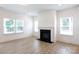 Spacious living room with fireplace, multiple windows allowing natural light, and wood-look flooring at 512 Beverly Cir, Charlotte, NC 28270