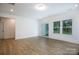 Inviting living room features a sliding glass door and large window with neutral paint and flooring at 512 Beverly Cir, Charlotte, NC 28270