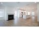 Open-concept living room features a fireplace, leading to a modern kitchen with a large island at 512 Beverly Cir, Charlotte, NC 28270