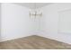 Bright and airy living room features light hardwood flooring, white walls, and large windows at 512 Beverly Cir, Charlotte, NC 28270