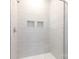 Close up of glass shower with built in shelves and light tile at 512 Beverly Cir, Charlotte, NC 28270