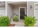 Close-up of the front door entrance, featuring an outdoor rug, plants, and the house number at 524 Tayberry Ln, Fort Mill, SC 29715
