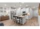 Well-lit kitchen with a large island, white cabinets, and stainless steel appliances at 524 Tayberry Ln, Fort Mill, SC 29715