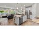 Open-concept kitchen with a stainless steel refrigerator and kitchen island at 524 Tayberry Ln, Fort Mill, SC 29715
