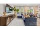 Inviting living room with a large sectional sofa, modern entertainment center, and natural light at 524 Tayberry Ln, Fort Mill, SC 29715