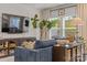 Cozy living room featuring a comfortable blue sofa, entertainment unit, and sunlit windows at 524 Tayberry Ln, Fort Mill, SC 29715