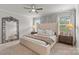 Bright and airy main bedroom with carpet flooring, large windows, and ceiling fan at 524 Tayberry Ln, Fort Mill, SC 29715